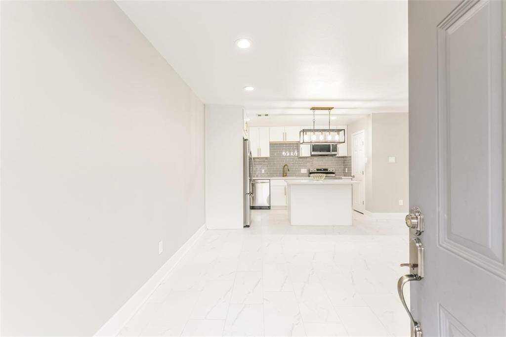 As you come in, you're immediately greeted with a seamless open floor plan with a flow to the dining and kitchen