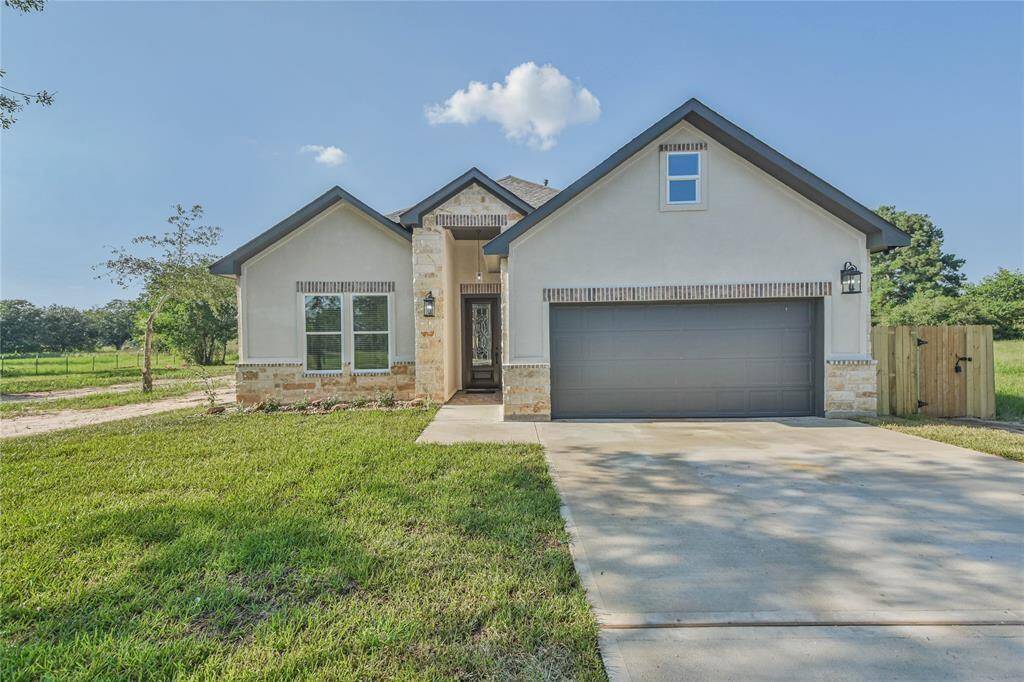 Welcome home to this new home with two car garage with double driveway and stone/brick exterior accents.