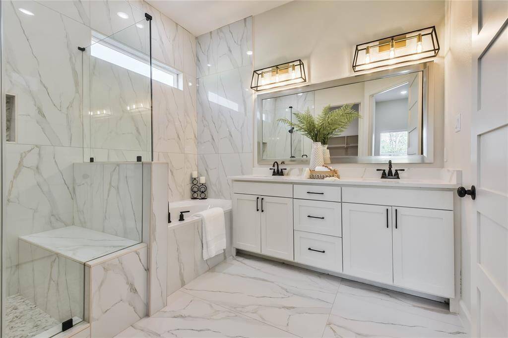 Take a look at this WOW Primary Bathroom with floor to ceiling accent wall, step in shower, tub and double vanity.