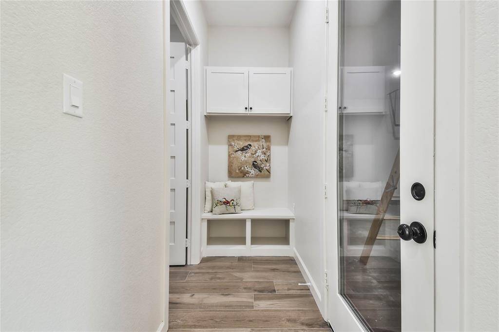 Mud room conveniently located near Garage. Notice the glass & steel door leading to the garage.