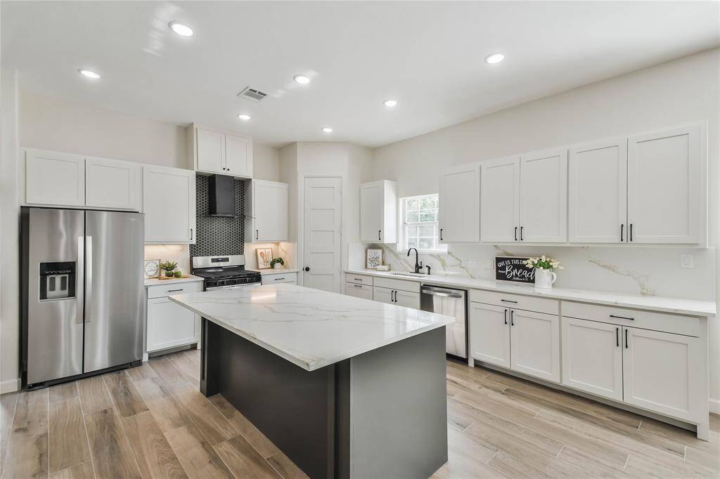 Large kitchen island that easily sits 4 and look at all the cabinet space.