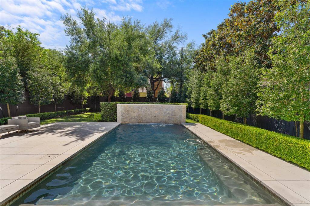 Additional view of this modern pool and serene landscape.