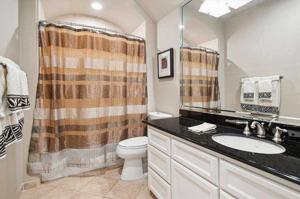 A full en suite bath providing privacy and comfort for guests in a downstairs private retreat.