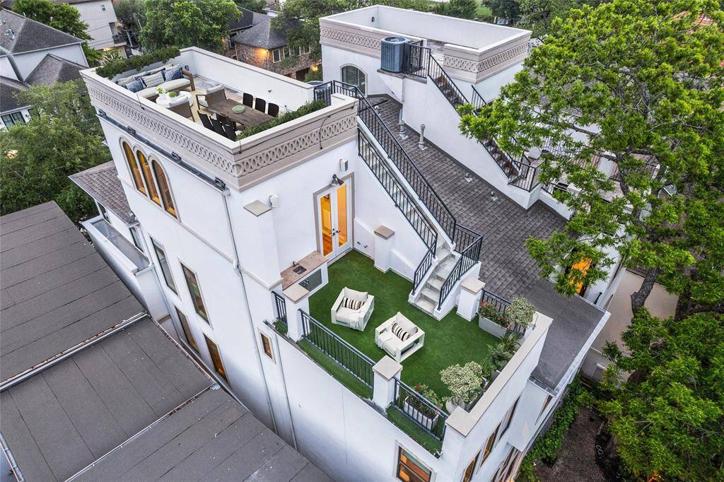 View of dual terraces - Providing wow factor with tree tops and Houston skyline views. Equipped with outdoor kitchen and more. (Digitally staged terrace.)