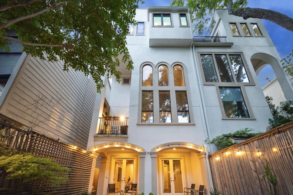 This custom home is nearly wrapped in foliage from every window.