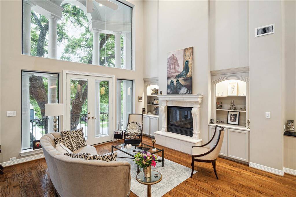 Alternate view detailing built in storage, fireplace and soaring ceilings.