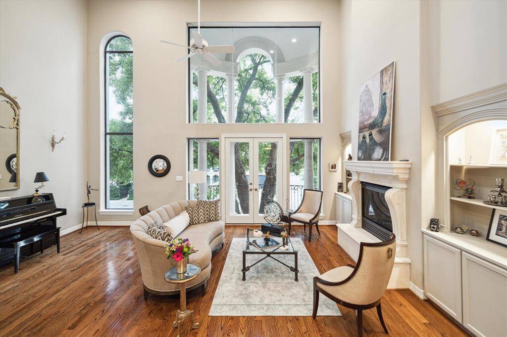 You'll find an expansive formal living with floor to ceiling window scape, fireplace, balcony, gleaming hardwoods and more.