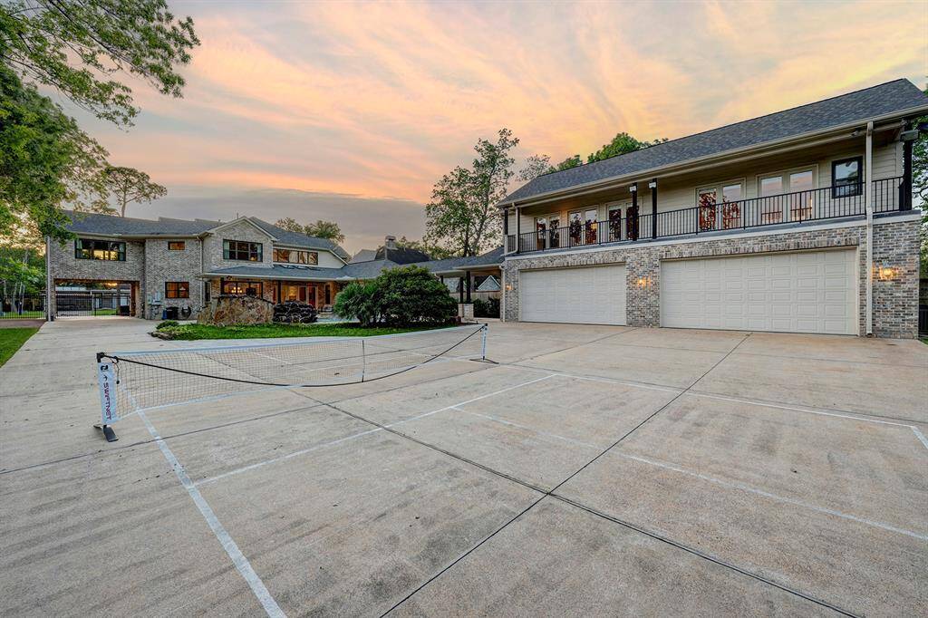 Pickleball court on driveway next to the four car garage and 1,014 sf guest aparment