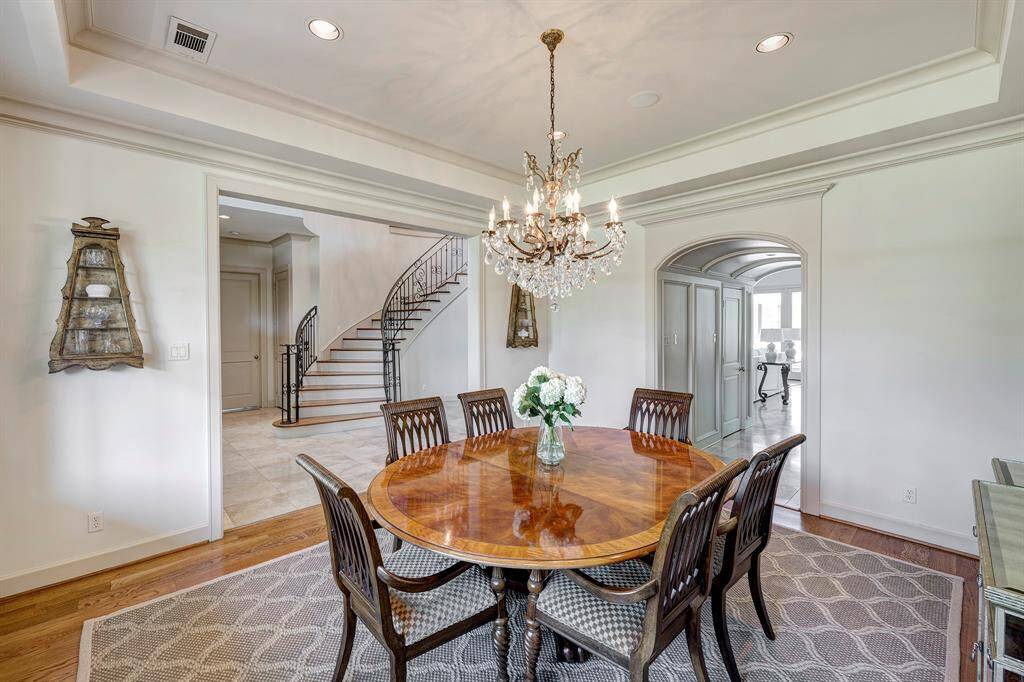 Formal dining with three storage closets through the archway
