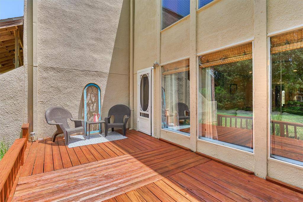 Screened backdoor for cool days, and a generous deck for entertaining! Note the wall of windows transcending outdoor/indoor living area!