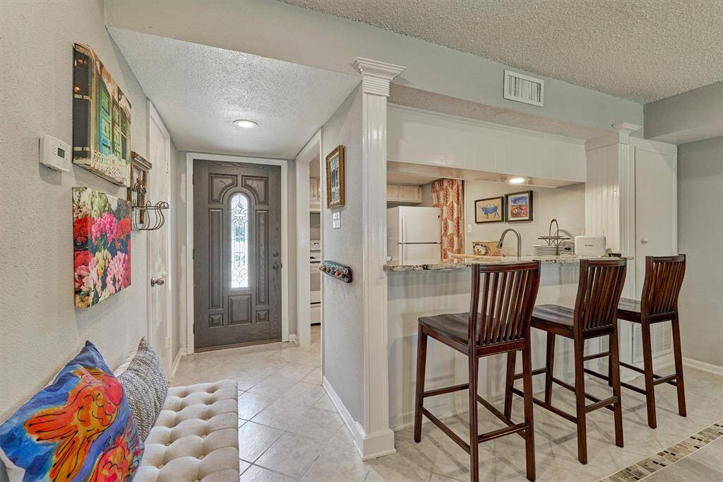 Charming entry and kitchen open to dining and living space and added breakfast bar seating!