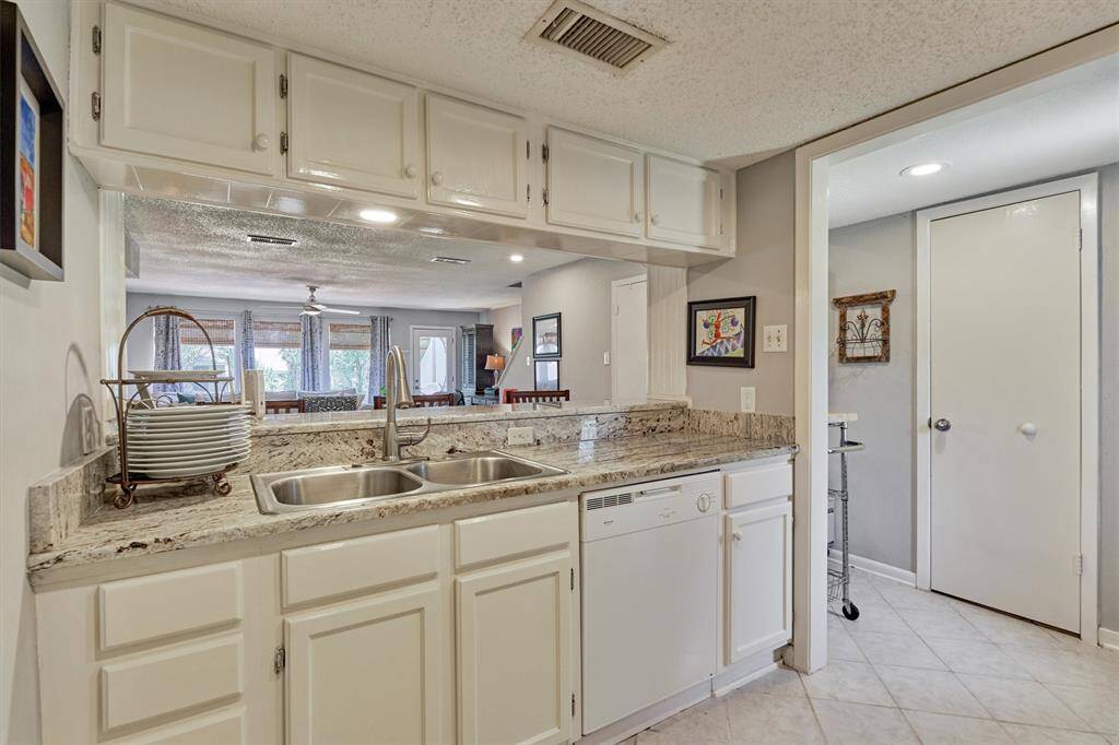View from the kitchen into the den and back deck! Door to the right is the half bath.