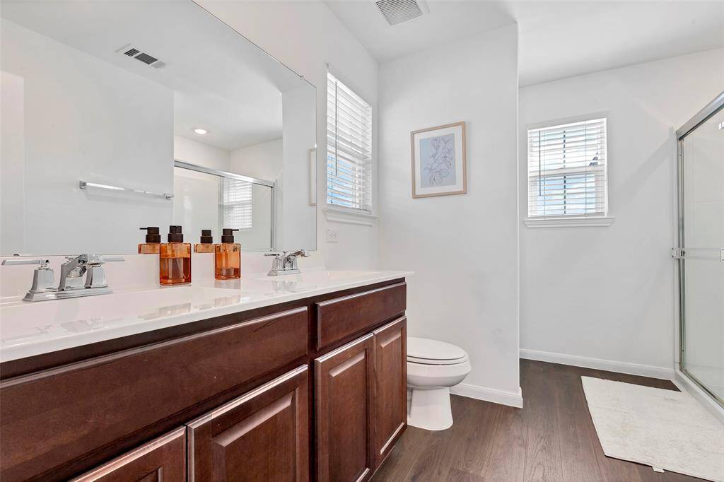 A large master bathroom that includes an oversized walk in shower and double vanities!