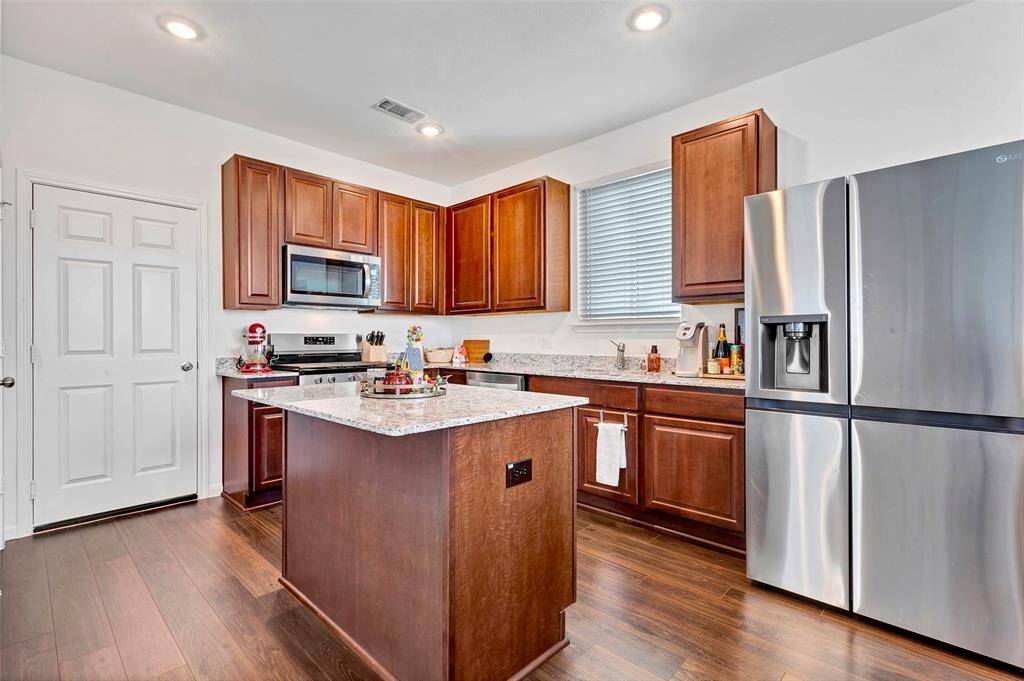 A large island is the center of this spacious kitchen.