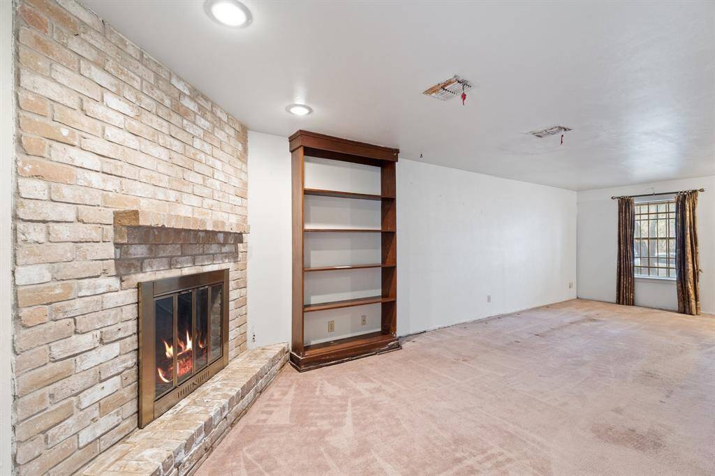 Another View of the Living Room! Enjoy the warmth of the fireplace in this cozy and well-lit area.
