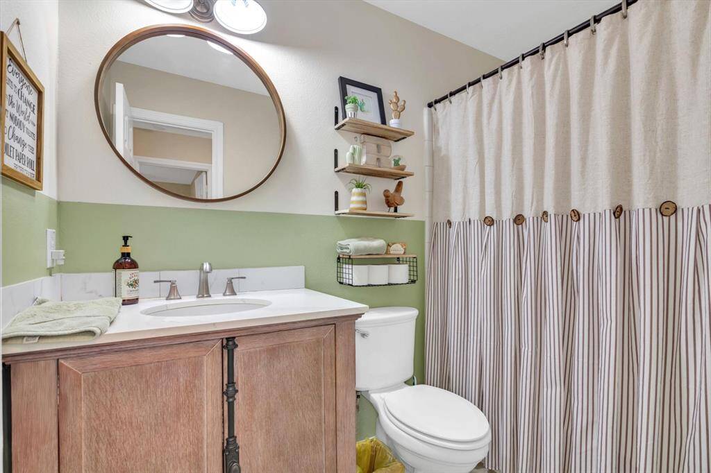 Bathroom 2 offers a tub/shower combo and custom vanity