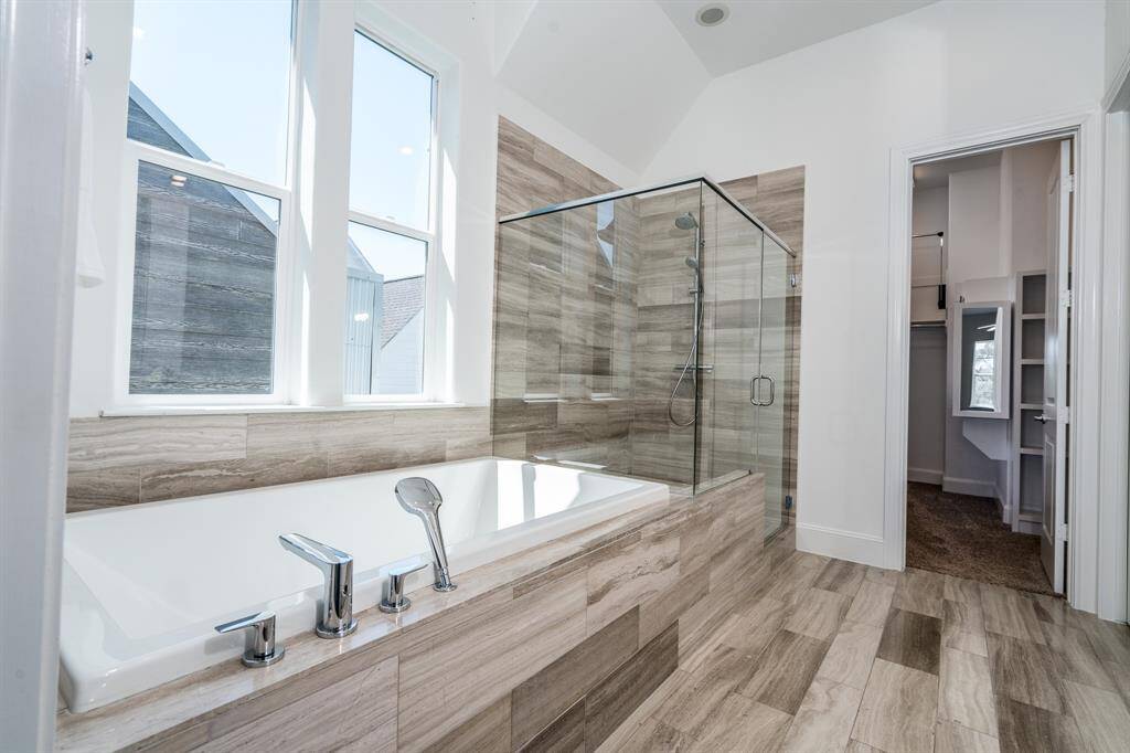 the large soaking tub and shower make this primary bath a true retreat.