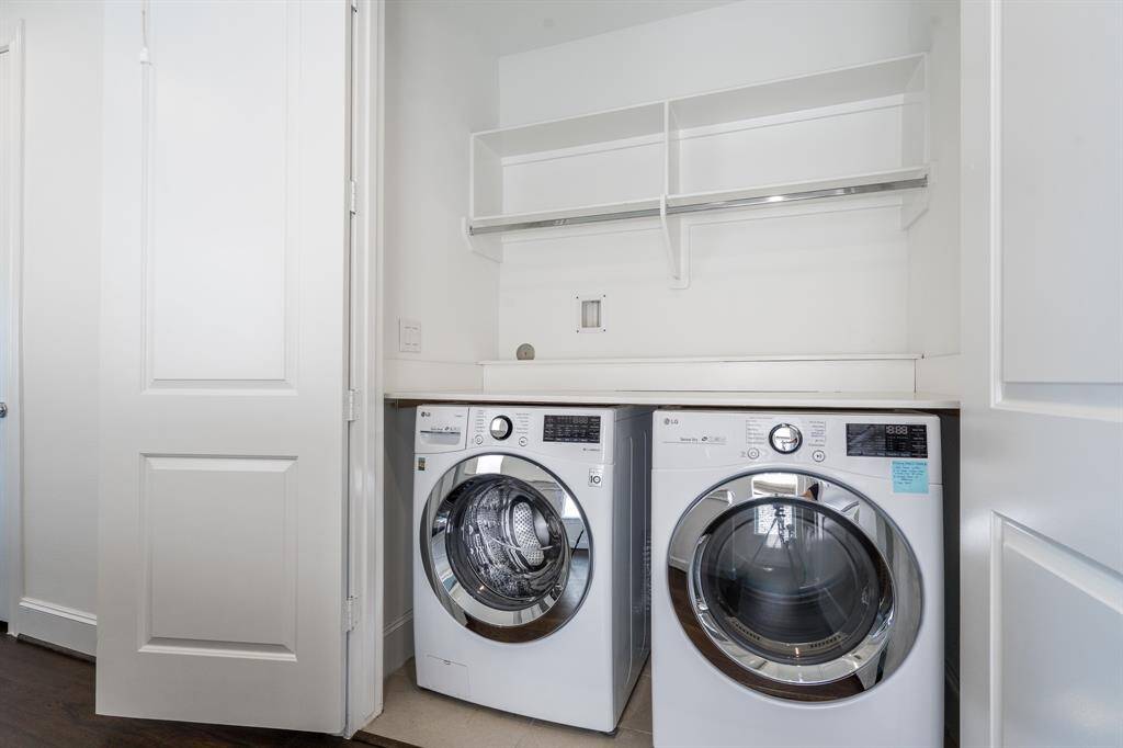 The laundry closet is located on the third floor, convenient to two of the three bedrooms. Notice the storage and folding table.