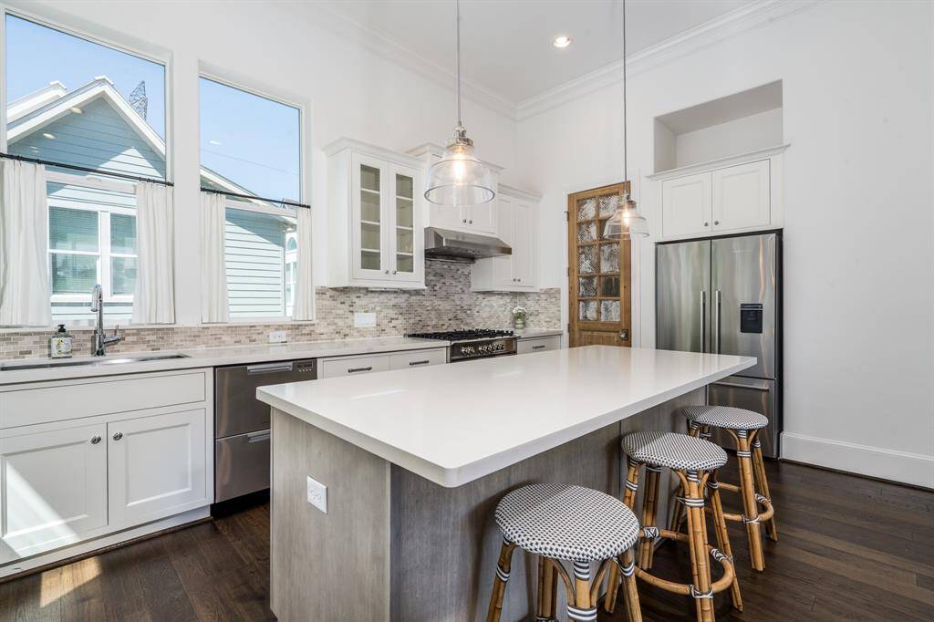 The large island provides seating and don't miss the pendants.