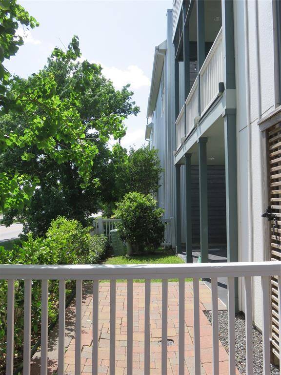 Notice the large green space with the front porch and second floor balcony as well as the lush landscaping.