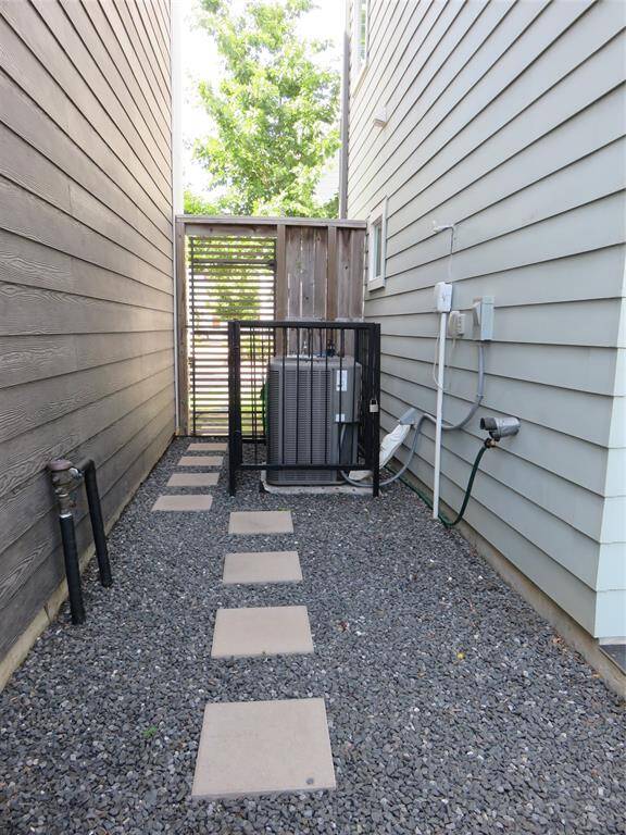 This is the entrance guest will use to get to the front door. The pavers are surrounded by gravel and there is a outdoor sink behind the AC unit.