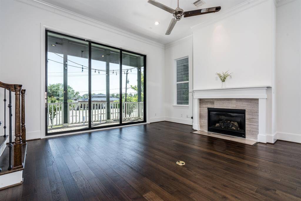 The living area has a fireplace and sliding glass door leading to the balcony.