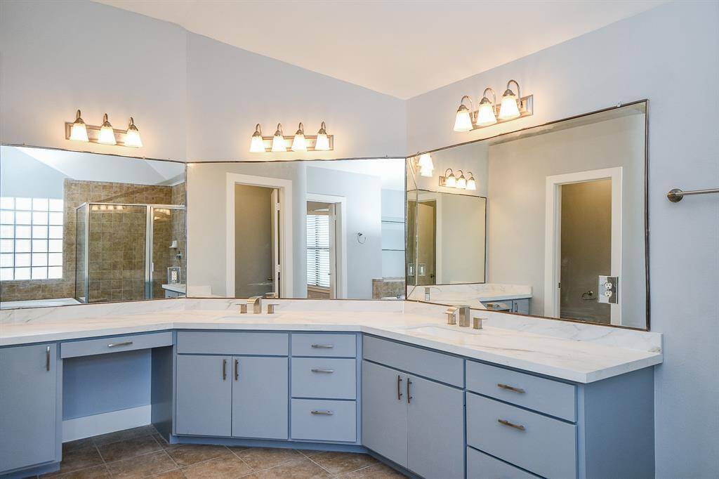 Huge open bathroom with double sinks, jet tub, and separate shower.
