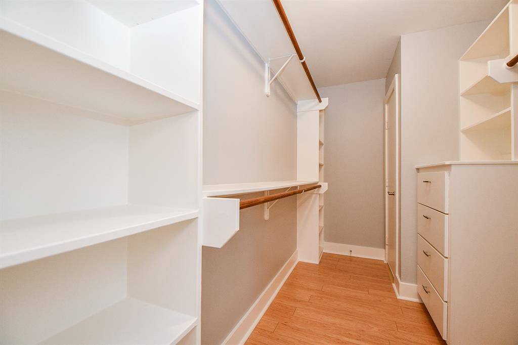 Primary closet with built-in storage.