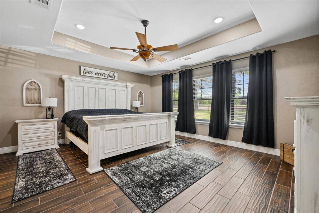 Spacious primary room with recessed ceiling and tons of natural light from the big windows