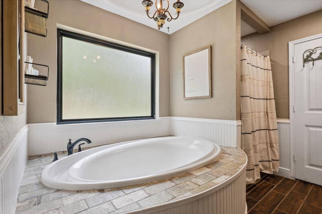 Primary bathroom has a soaking tub, separate shower, and conveniently located between the Primary bedroom and the huge walk-in closet.