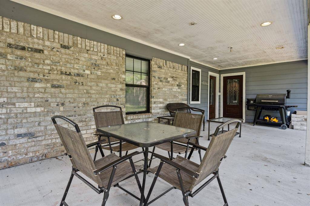 Covered, concrete back patio is a great size. What a cool place to sit and enjoy a drink after a long day of work.