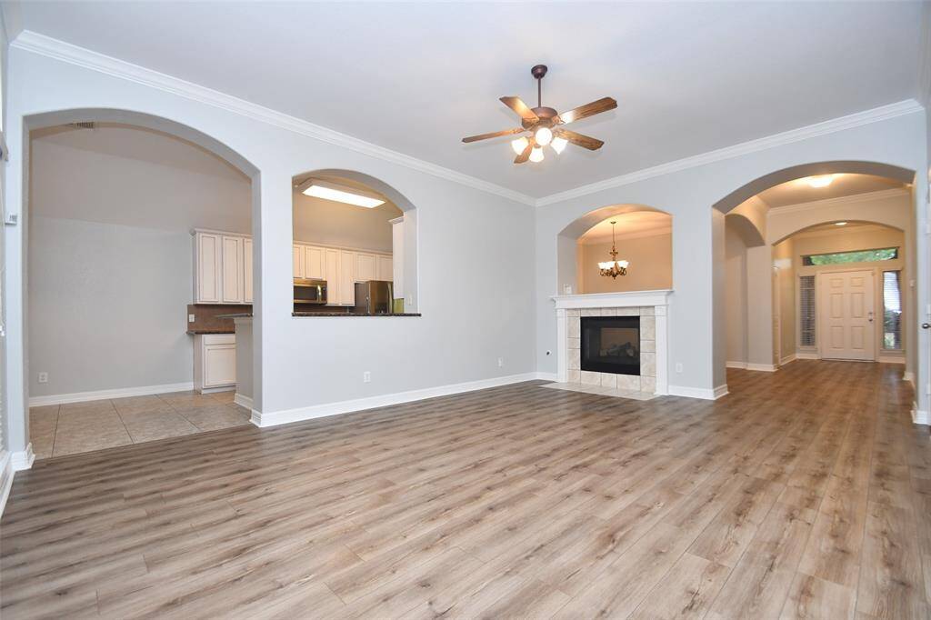 Living room with elegant flooring and dual sided fireplace