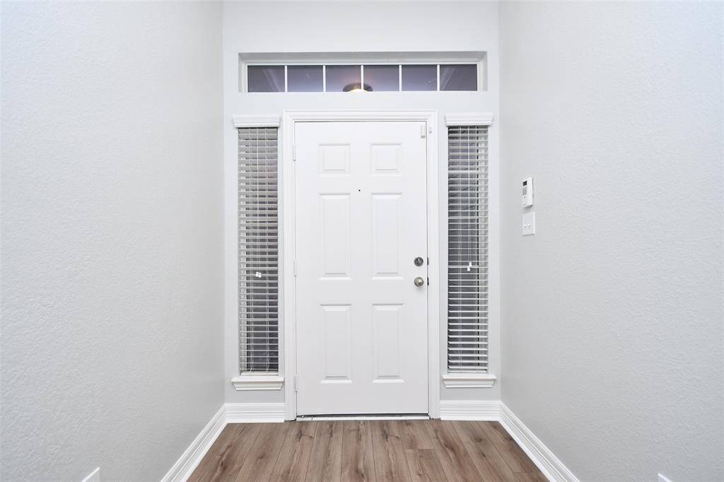 Welcoming entryway leading into the dining room and family room area.