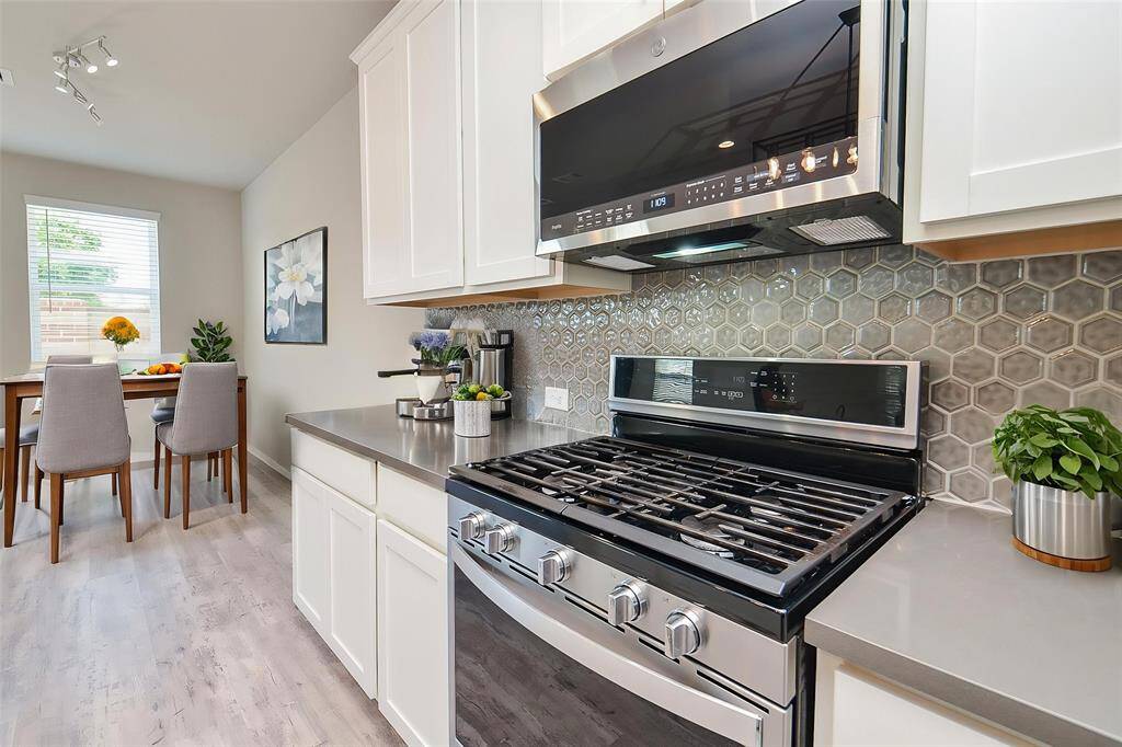 The ample white cabinetry provides abundant storage, keeping your space organized and clutter-free.