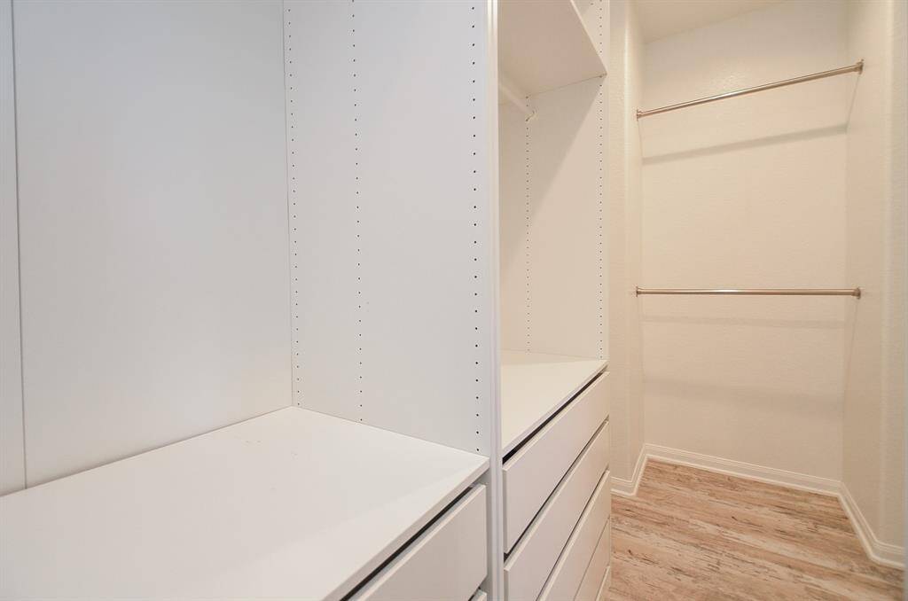 Discover this spacious primary closet, with ample built in shelving.