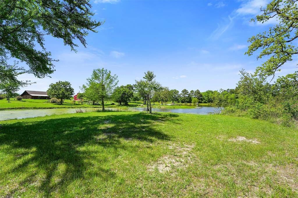 This serene lakefront property offers stunning panoramic views of the water, lush greenery, and open blue skies. Nestled beneath mature shade trees, the gently sloping grassy terrain provides the perfect setting for a custom-built home, weekend retreat, or peaceful getaway.