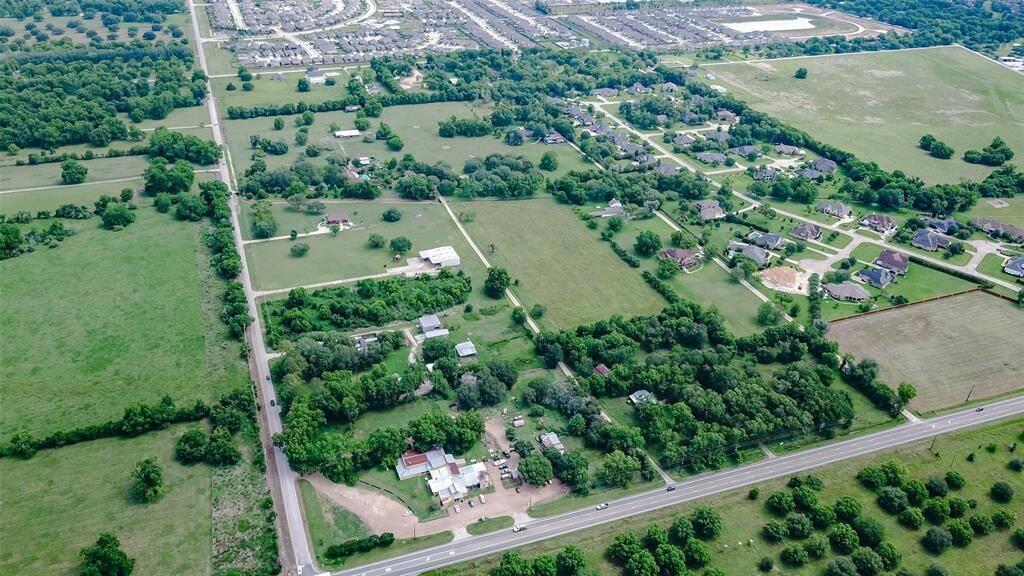 Two parcels (R228761 and R364536) totaling 10.065 acres, all AG exempt with no restrictions. The property includes a barn on parcel R228761 that needs some work. FM 359 Road borders the bottom and McCrary Road to the left side.