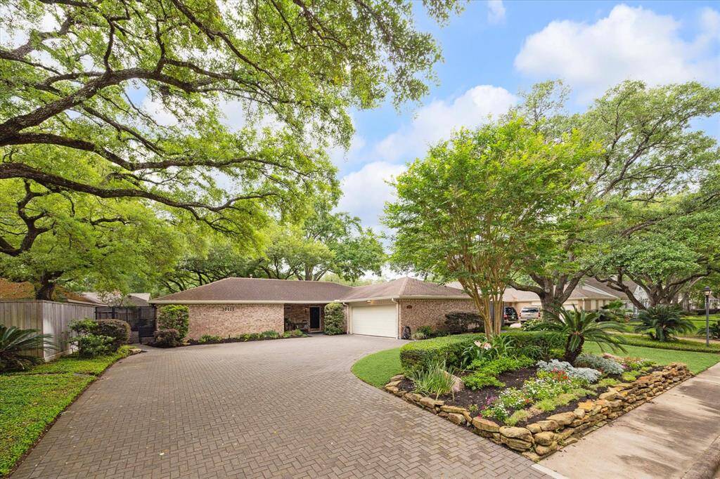 This single story home boasts 3 bedrooms and 2 1/2 bathrooms and is situated on a tree lined street