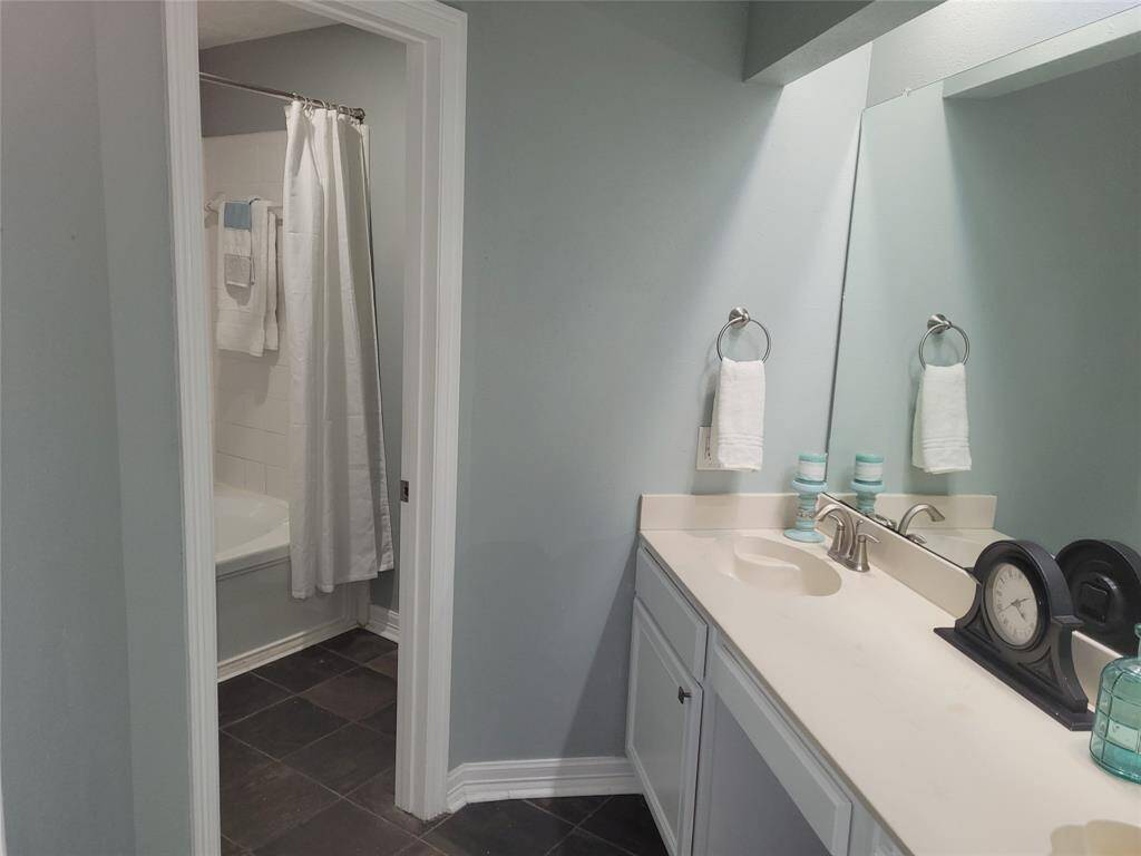 Primary bath offers double sink vanity area separate from tub/toilet area, large walk-in closet