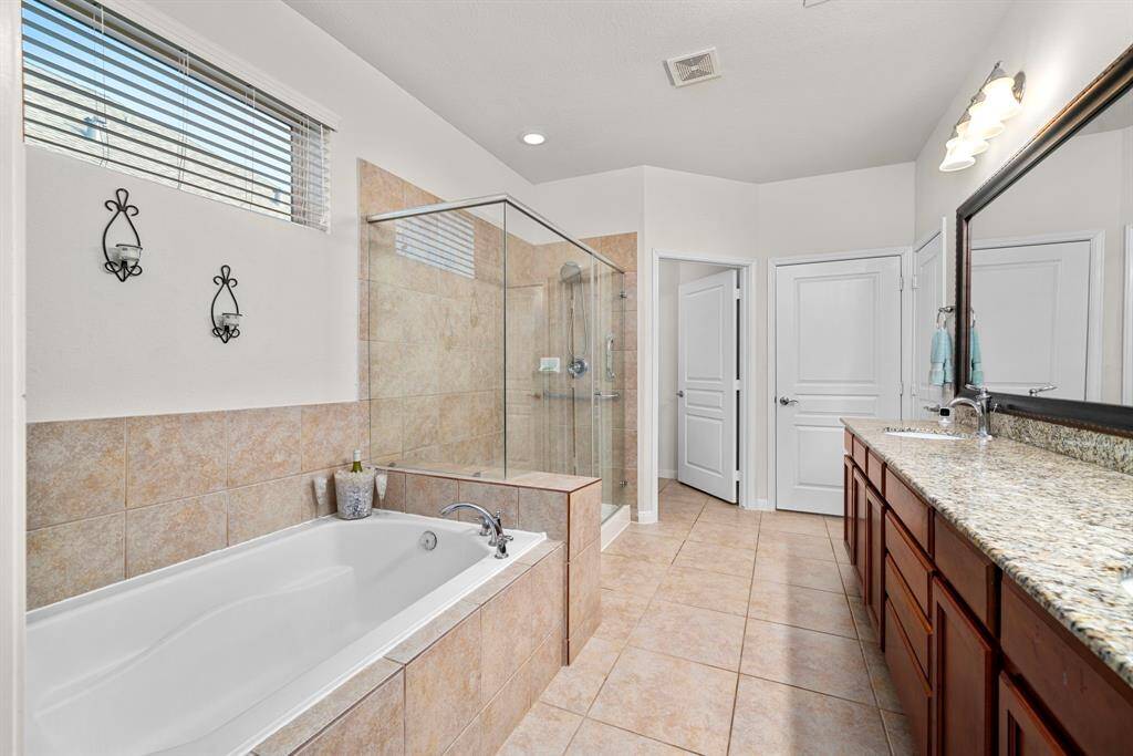 Primary Bathroom with a separate tub and shower