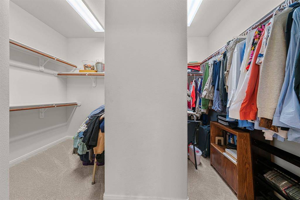 A very large closet in the primary bathroom with plenty of storage