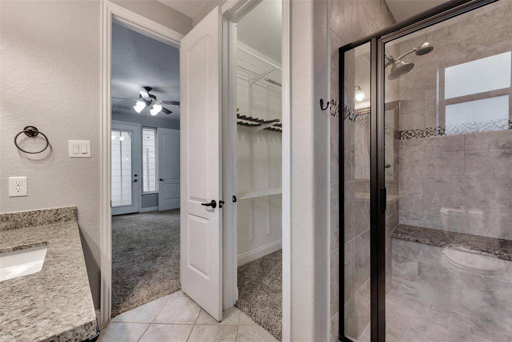 The secondary bath is spacious and includes a shower and a walk-in closet.