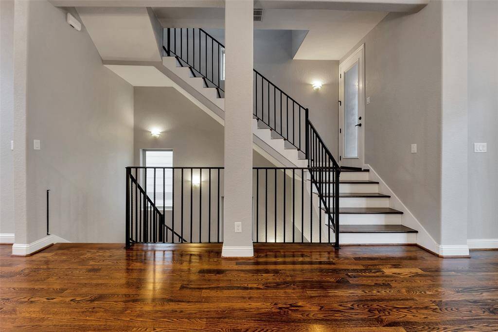 The stairs from the main floor lead to the balcony on the right and the third floor.
