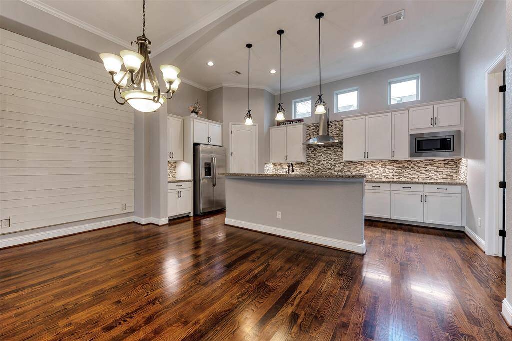 A closer view of the large kitchen with the island bar and dining space.