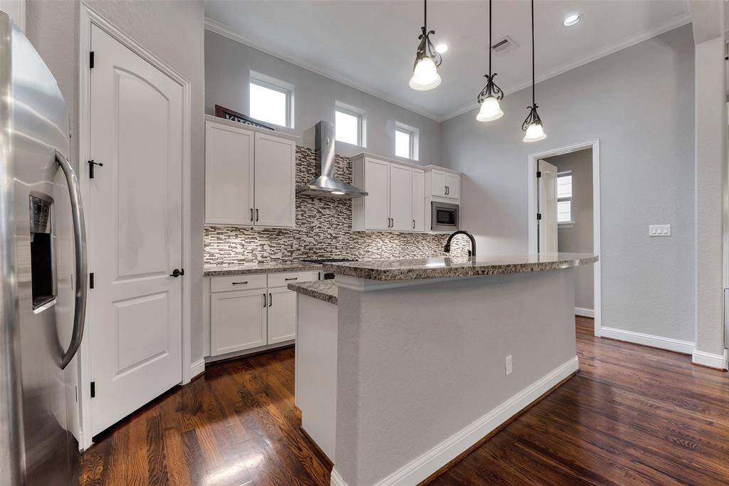 Freshly painted cabinets grace this lovely kitchen.