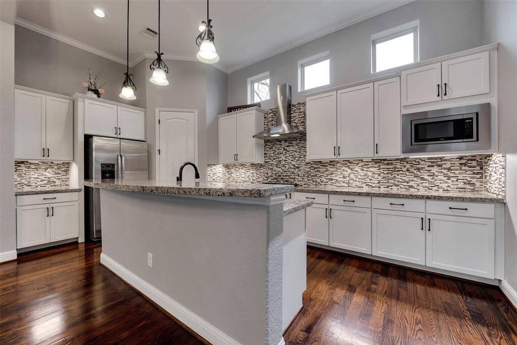 There is ample counter space for prepping, cooking, and entertaining in this kitchen. The island bar offers a great place to gather with family and friends.