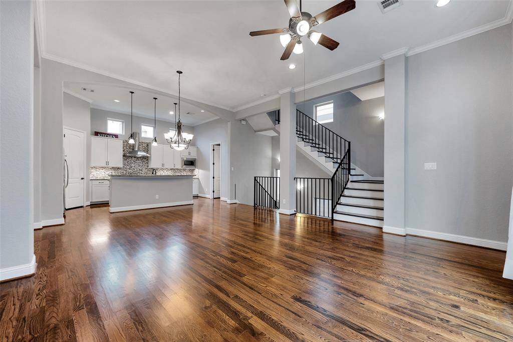 This grand living room with high ceilings is a great space to relax, read, entertain, or watch the tele.