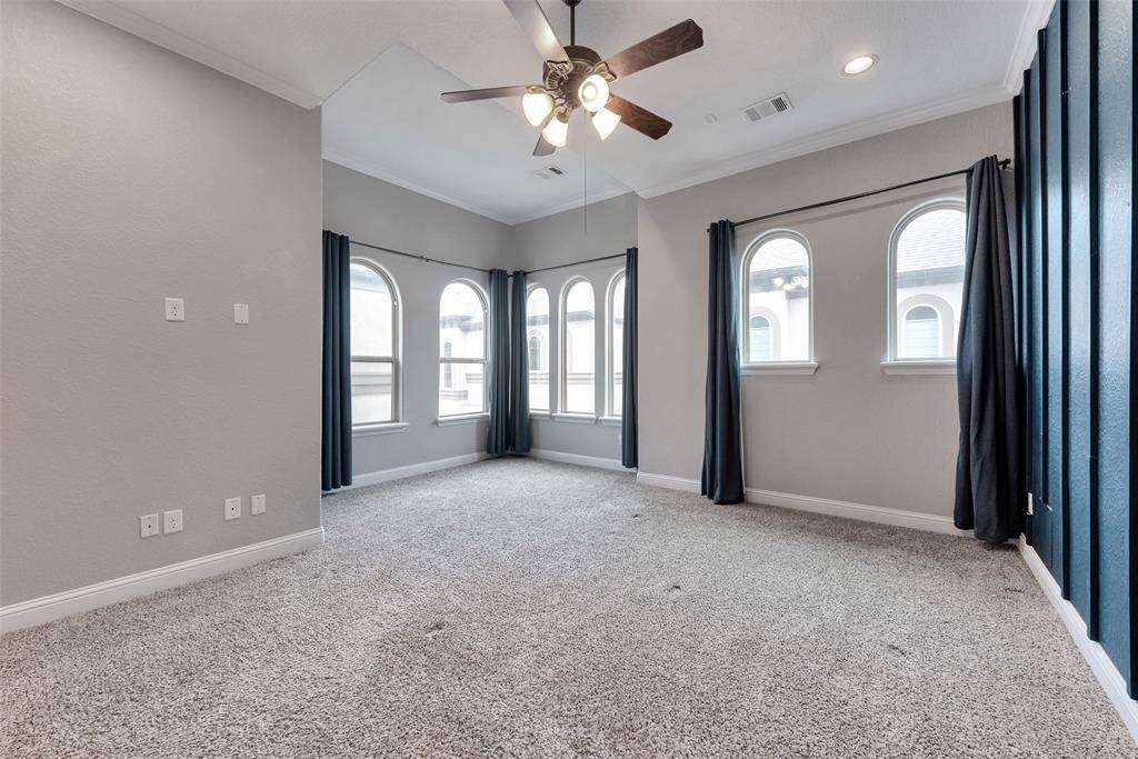 You will love the primary bedroom with high ceilings and a room full of windows that bring in plenty of natural light.
