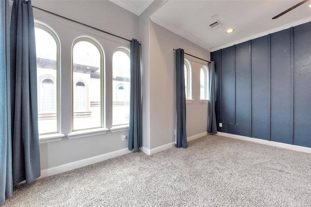 A partial view of the primary bedroom with the wall of windows.