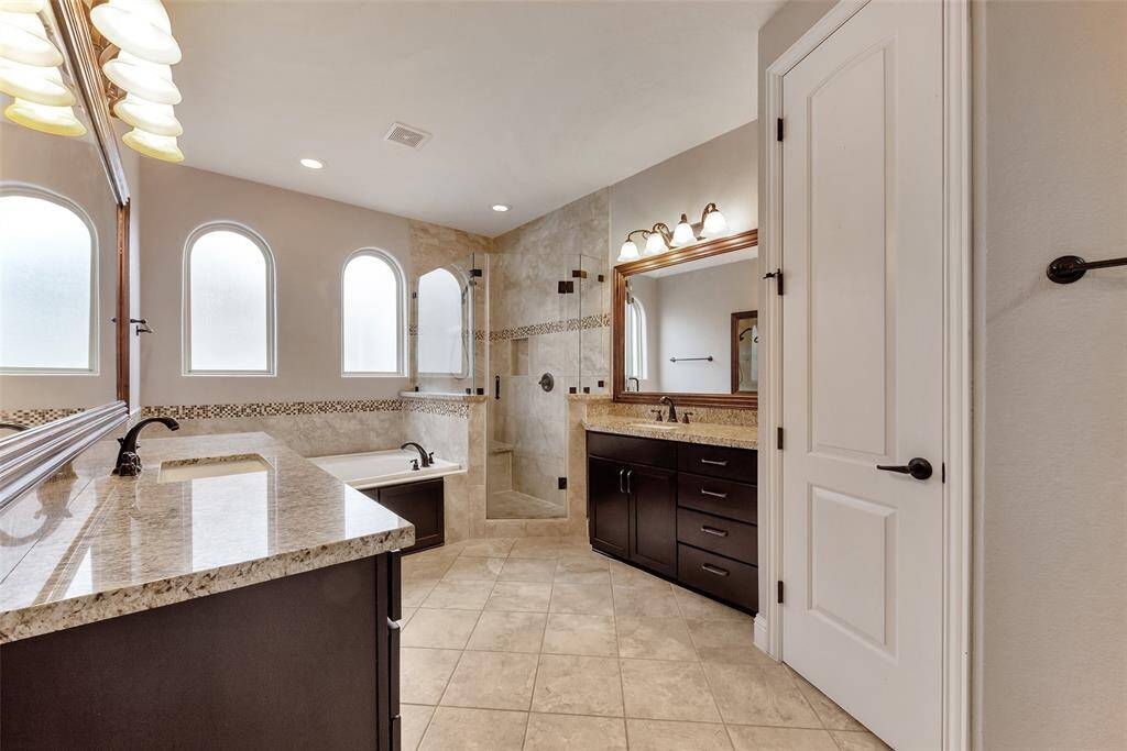 The primary bath is large and has plenty of cabinets for all your needs.